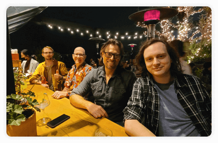 smiling men sitting at a table